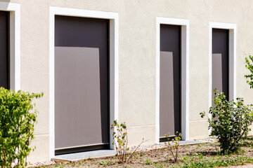 Window Blinds. Modern Fabric Roller Blind on Large Panoramic Windows Door. External Shutters on...