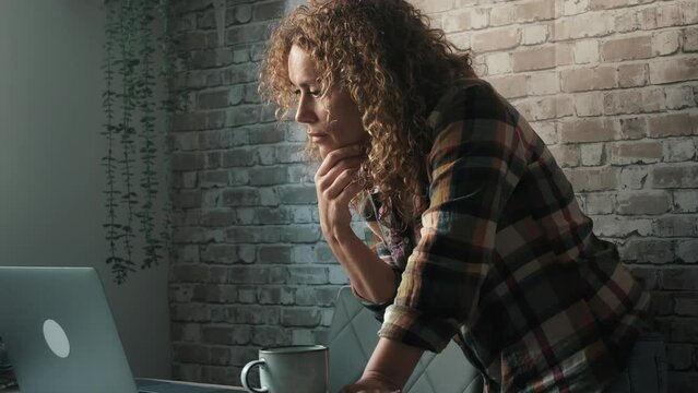 One young modern woman entrepreneur busy in small business home workplace activity online using laptop at the desk. Beautiful businesswoman working from home. Modern people and internet technology job