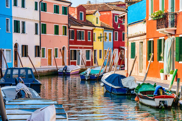 Fototapeta na wymiar Colorful houses along the water canal in the island of Burano, Venice.