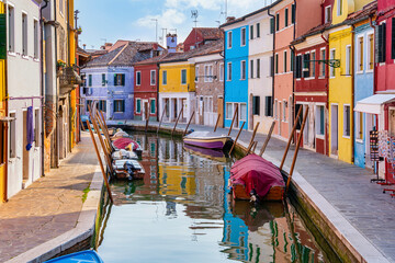 Colorful houses along the water canal in the island of Burano, Venice.