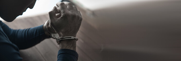 sad man hand handcuffs