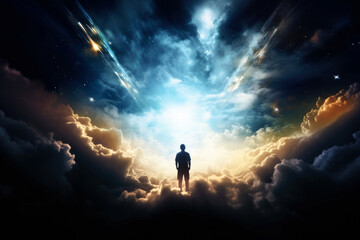 Fototapeta premium Faith. Silhouette of man standing on cloud and looking at the light