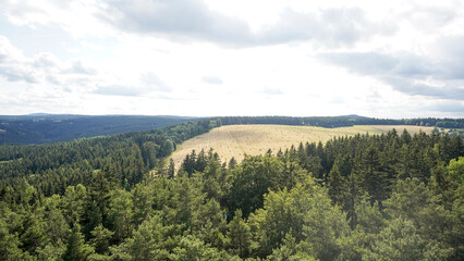 Fototapeta na wymiar Krásno lookout tower with spiral staircase overlooking green mountain hills in Krásno, Czechia, Czech Republic.