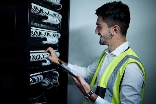 Technician, check server cables and tablet with system, happy or maintenance on web app in night. IT expert man, engineer and digital touchscreen for inspection, idea or smile in room for data center