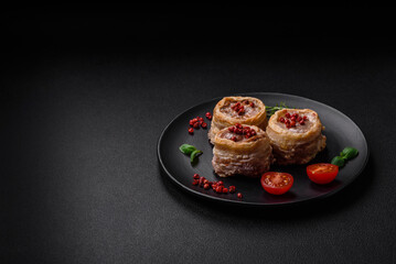 Delicious baked meat roll wrapped in bacon with salt, spices and herbs