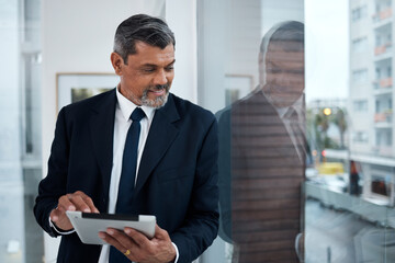 Fototapeta premium Business, window and senior man with a tablet, thinking and connection with network, inspiration or digital planning. Consultant, employee or entrepreneur with technology, glass or idea for a project