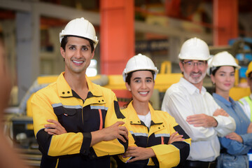 Portrait of group diversity workers industrial team, Manager, Engineers, and technicians wearing safety uniform workwear standing cross arms look confident in an industrial manufacturing factory.