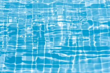 Blue water with ripples on the surface. Defocus blurred transparent blue colored clear calm water surface texture with splashes and bubbles. Water waves with shining pattern texture background.