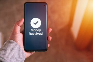 Woman transfering money online using apps on smartphone. Selective focus. Concept of financial...