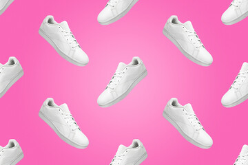 Pattern of white sneakers isolated on pink background. Sportive pair of shoes for mockup. Fashionable stylish sports casual shoes. Modern and minimalist wallpaper.