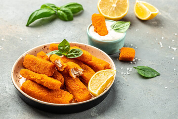 Tasty fried fish fingers served with lemon and sauce. banner, menu, recipe place for text, top view