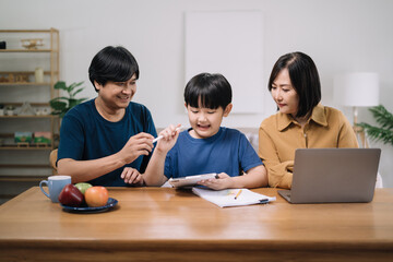 work from home education concept and family at home sitting at desk business woman working on internet in laptop child writing in notebook