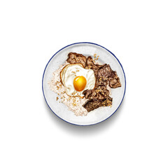Tapsilog : a mouthwatering Filipino breakfast delight; a delectable ensemble of beef tapa, garlic fried rice, and a perfectly fried egg harmoniously arranged on a pristine white plate.
