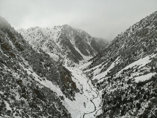 Tian Shan mountains in Kyrgyzstan at winter. Aerial drone view. Flying over. High quality photo