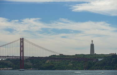 Tagus river Lisboa. 25 de Abril Bridge and Christ the King monument in Portugal. High quality photo