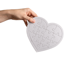 Hand holding heart puzzle isolated on white background. Donation, love, charity concept
