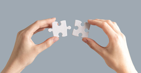 Hands connecting puzzle pieces. Connection, mental health, match concept