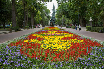 Park in Bishkek with flowers and small train. High quality photo
