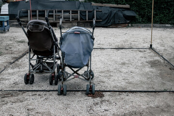Old broken baby carriages. Baby carriages abandoned on the street