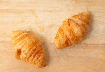 Close up Fresh croissant on wooden background. Top view position