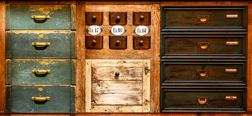 Front of vintage drawers, different in size, shape, color and design