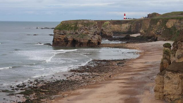View of a Rocky Seashore With a Lighthouse (Marsden Beach, England)