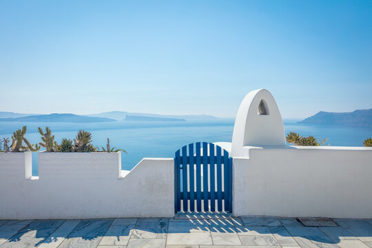Fototapeta Conceptual background - Santorini. Greece, Santorini island, Oia - white architecture and the door to heaven. Abstract background, empty space. Greek Islands, Santorini