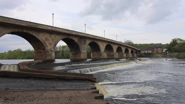 View of the Old Stone Bridge With Arches Across the River in Cloudy Weather