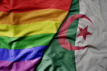 big waving realistic national colorful flag of algeria and rainbow gay pride flag .