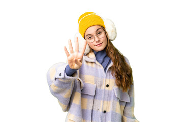 Teenager girl wearing winter muffs over isolated chroma key background happy and counting four with fingers