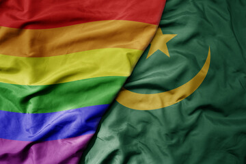 big waving realistic national colorful flag of mauritania and rainbow gay pride flag .