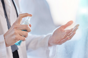 Sanitizer, cleaning and hands of doctor with protection from bacteria or hygiene against virus at the workplace. Disease, closeup and professional medical employee or healthcare worker for wellness