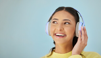 Woman with smile, headphones and mockup in studio thinking with technology on mobile app and...
