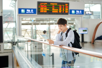 a young man holding a map at a train station
