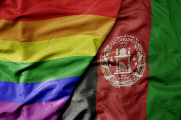 big waving realistic national colorful flag of afghanistan and rainbow gay pride flag .