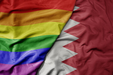 big waving realistic national colorful flag of bahrain and rainbow gay pride flag .