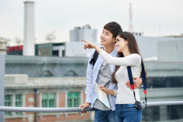 During the trip, a college student couple is looking for their way with a map at Seoul Station...