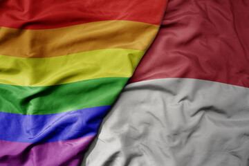 big waving realistic national colorful flag of indonesia and rainbow gay pride flag .