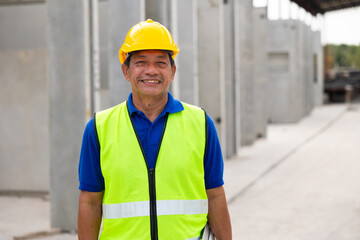 Happy and smile senior Asian professional Engineer factory. Engineering worker in safety hardhat at factory industrial facilities. Heavy Industry Manufacturing Factory. Prefabricated concrete walls