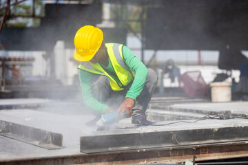 Labor man cutting steel at the construction site. Heavy Industry Manufacturing Factory....