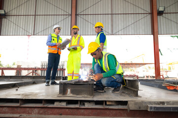 welding. Asian man worker weld metal with a arc welding machine at the construction site. Heavy Industry Manufacturing Factory. Prefabricated concrete walls