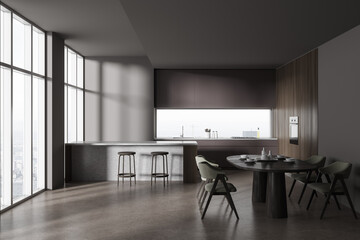 Grey home kitchen interior with bar island and dining table, panoramic window