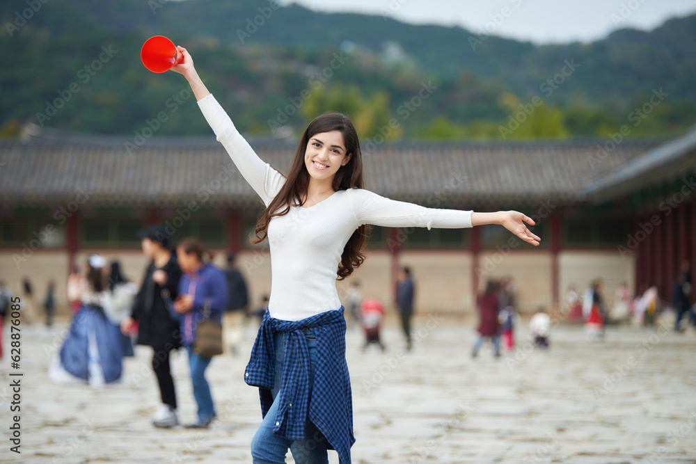 Wall mural a young woman with a loudspeaker guided by a tour guide at a tourist attraction in korea