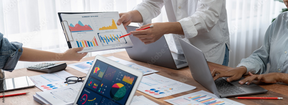 Poster Panorama shot analyst team utilizing BI Fintech to analyze financial report with laptop. Businesspeople analyzing BI power dashboard displayed on laptop screen for business insight. Scrutinize