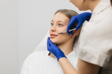 Naklejka premium Lip Augmentation. Woman Getting Beauty Injection For Lips