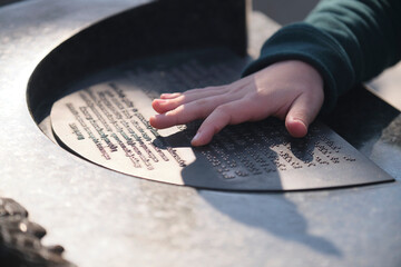 A child reads Braille for the blind with a small hand