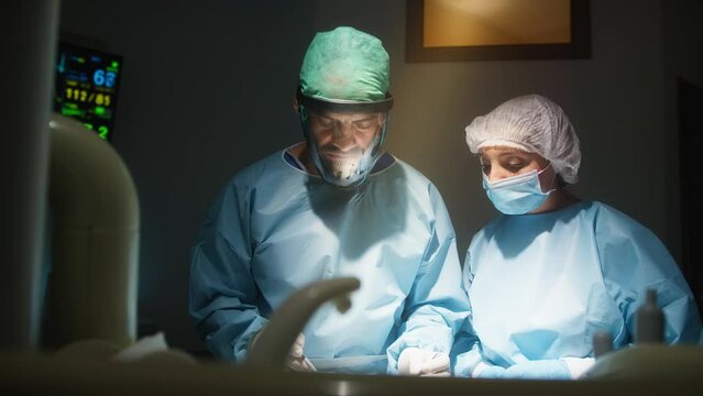 Medical staff performs complex surgical plastic breast operation