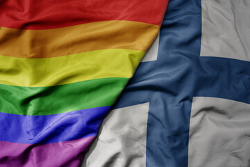 big waving realistic national colorful flag of finland and rainbow gay pride flag .