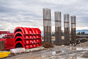 Red panels of round formwork on the construction of the bridge