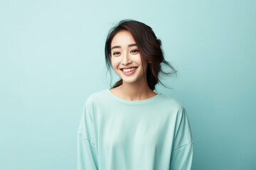 Fototapeta premium Asian young woman in casual clothes on a light blue background studio portrait